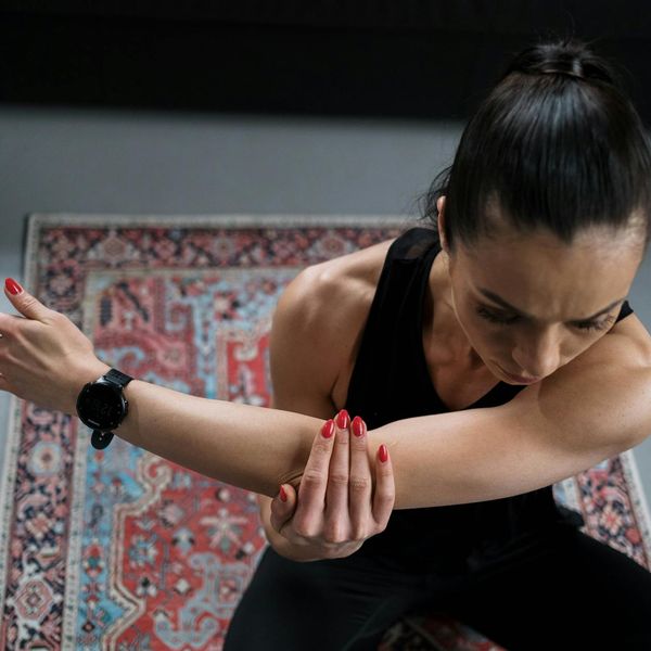 Person stretching outdoors at sunrise, feeling vital and energized.